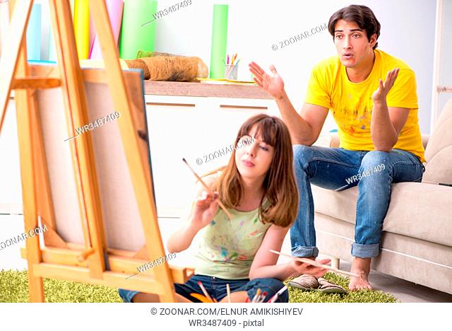 Young couple enjoying painting at home
