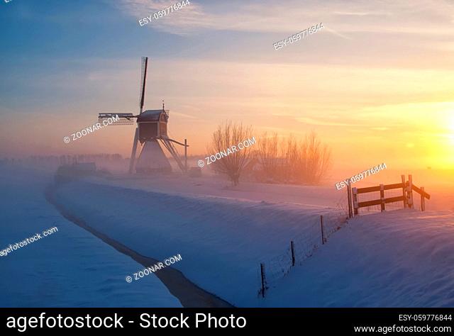 Wingerdse mill near Oud-Alblas in the Dutch region Alblasserwaard in a misty and wintry landscape