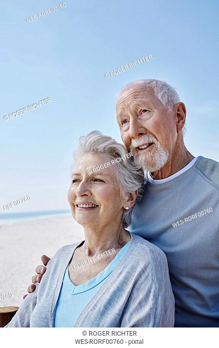 Smiling senior couple on the beach