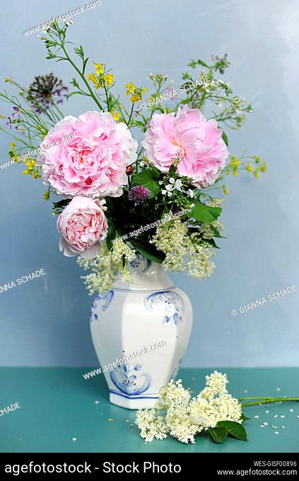 Vase with herbs and summer flowers