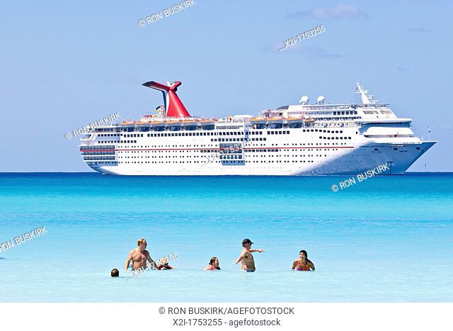 Cruise ship passengers play in water while ship is moored at Half Moon Cay, Bahamas