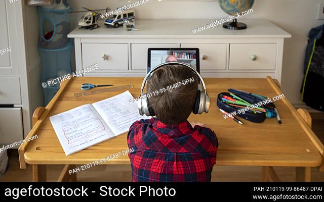 17 January 2021, Saxony-Anhalt, Magdeburg: A boy uses the Moodle learning platform for homeschooling. The Saxony-Anhalt education server