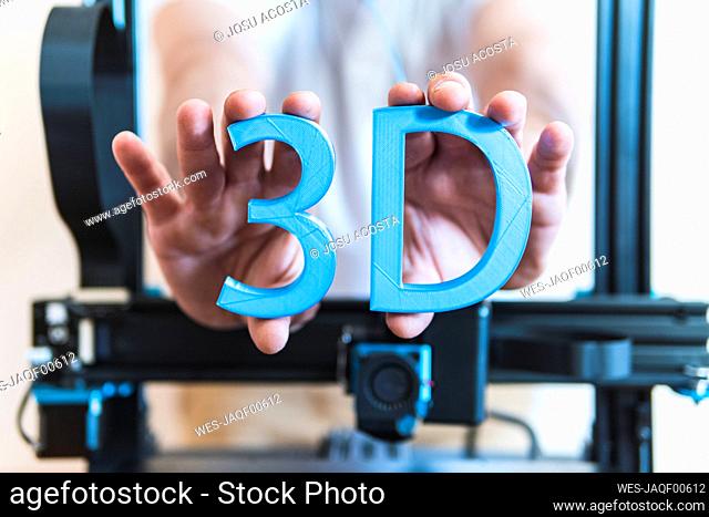 Male engineer showing 3D text through machinery
