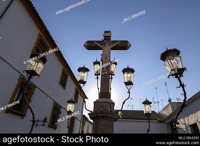 Girl contemplating the Christ of the Lanterns at sunset in the Plaza de Capuchinos in Cordoba Andalusia Spain