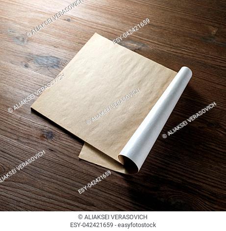 Blank open brochure or magazine on wood table background. Responsive design mockup
