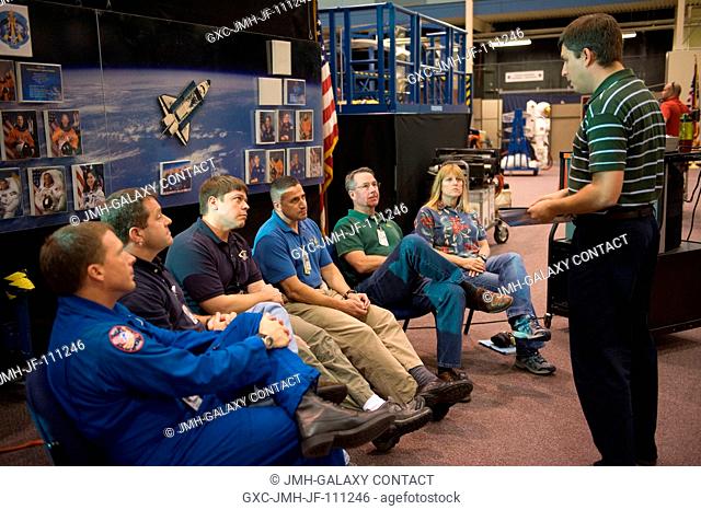 Crew trainer Patrick Jones (right) briefs STS-130 crew members during a training session in the Space Vehicle Mock-up Facility at NASA's Johnson Space Center