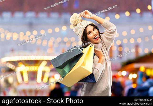 young woman in winter hat with shopping bags