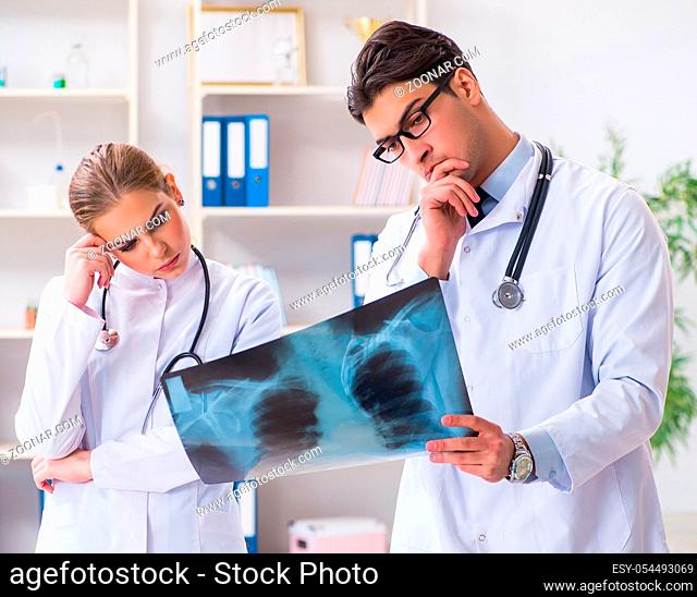 The two doctors examining x-ray images of patient for diagnosis