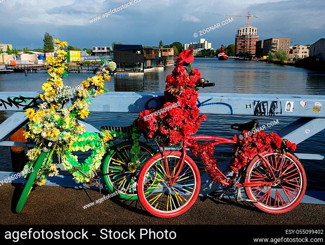 Bicycle decorated with flowers on a dutch bridge in amsterdam, the netherlands