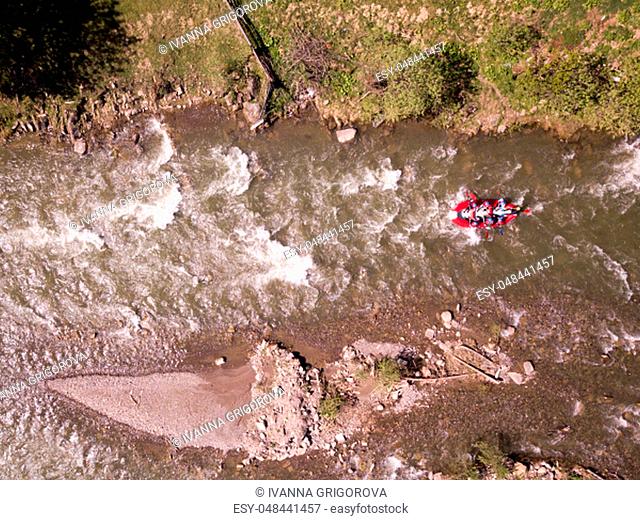 Aerial view of people having fun during rafting in the river/