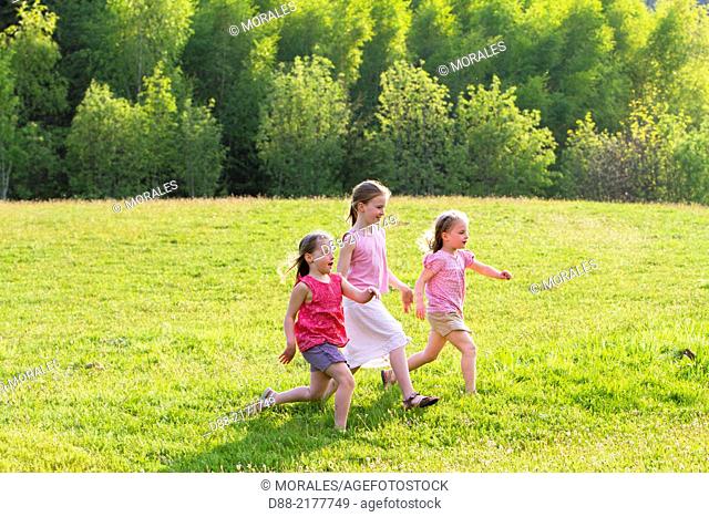 France, Bas Rhin, Urbeis near the Climont, girls in a meadow