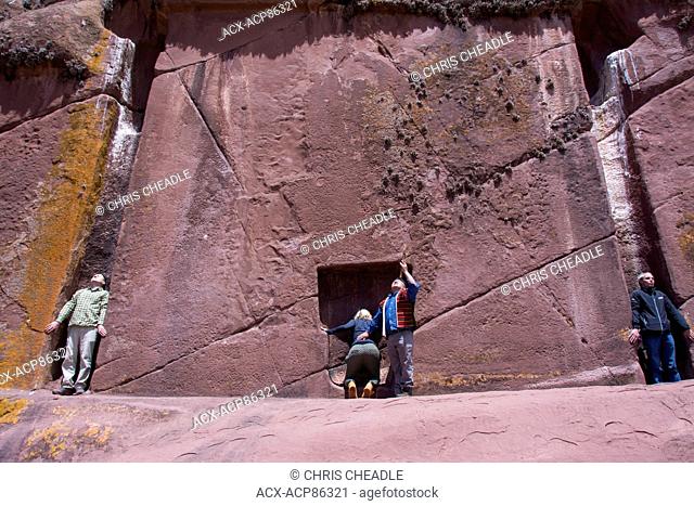 Peruvian shaman conducts ritual at Amaru Muru, a?mysterious Èdoorway? carved into a rock face, called the gateway to the 4th dimension, Lake Titicaca, Peru