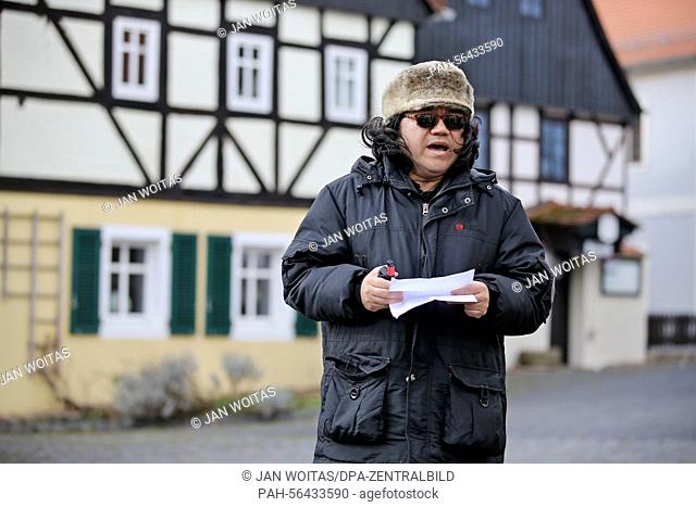 Chinese director Ran Hao stand on the village square during the filming of a scene for a Chinese romantic comedy in Hoefgen, Germany, 2 March 2015