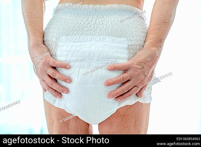 Asian senior or elderly old lady woman patient wearing incontinence diaper in nursing hospital ward, healthy strong medical concept