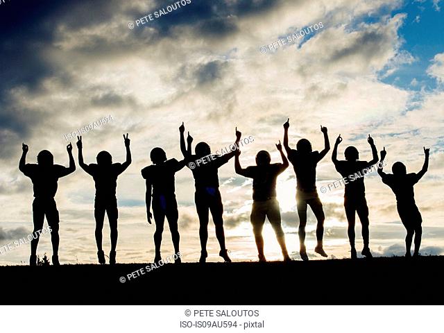 Silhouette of group of young american football players, celebrating