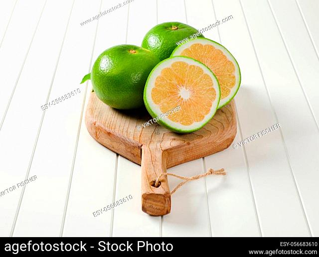 Sweetie fruits (green grapefruits, pomelits) on cutting board