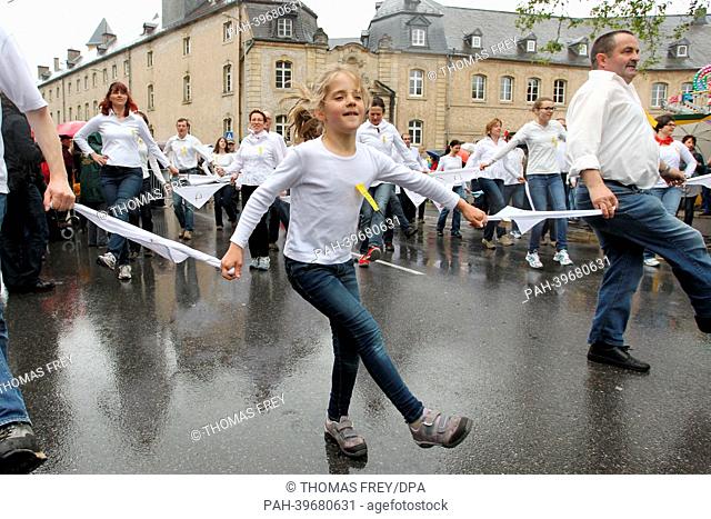 Participants in the dancing procession of Echternach hop ti polka tunes in rows through the streets to the grave of Saint Willibrord in the basilica in...