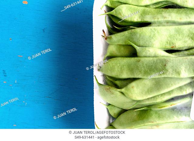 Green beans on wooden blue table
