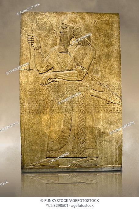 Assyrian relief sculpture panel of King Ashurnaspiral II with his sword and a staff. The panel is possibly from his private apartments