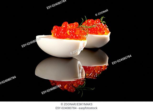 Luxury food. Caviar in eggs with dill