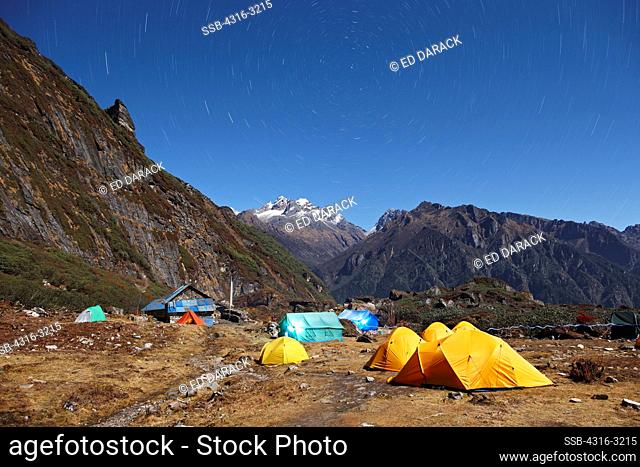 Tents rest beneath star trails at a trekker camp at Mumbuk in the Barun Valley, on a trek to Makalu Base Camp, eastern Nepal