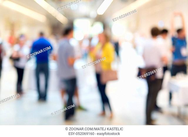 Abstract blurred people socializing during coffee break at business meeting or conference