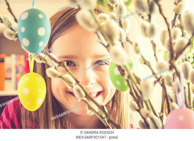 Portrait of smiling girl behind Easter bouquet