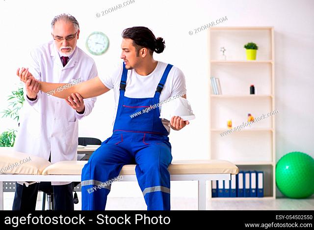 The young male contractor visiting old doctor