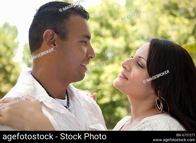 Attractive hispanic couple portrait in the park