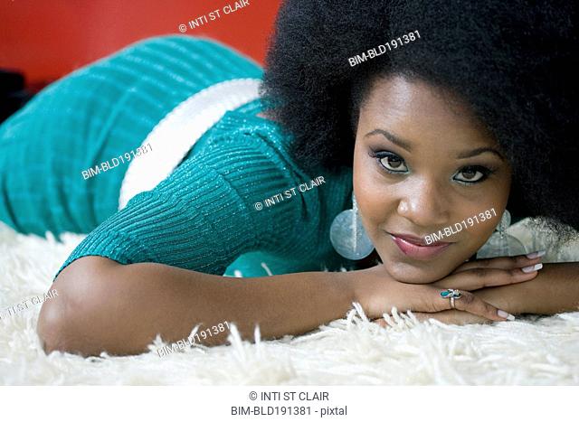 Glamorous mixed race woman laying on floor