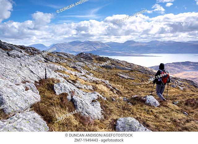 A hiker descending Sron a Garbh Choire Bhig in the Scottish Highlands