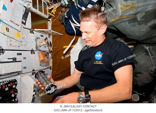 NASA astronaut Piers Sellers, STS-132 mission specialist, works with Group Activation Packs (GAP) on the middeck of space shuttle Atlantis while docked with the...