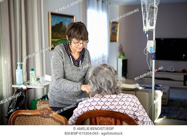 Reportage on a home health care service in Savoie, France. A nurse changes a patient with cancer?s parenteral nutrition pouch