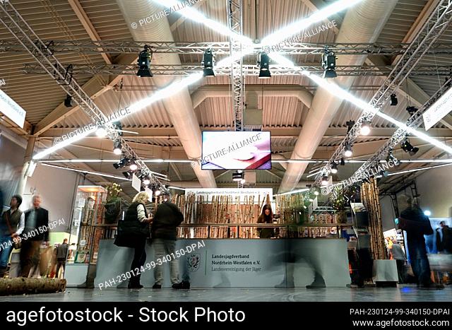 10 January 2023, North Rhine-Westphalia, Dortmund: Visitors walk past the stand of the Landesjgadverband NRW (wiping effect due to long exposure)