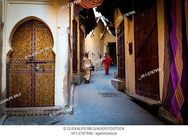 Fes, Morocco, North Africa. Passers in the narrow streets of the medina