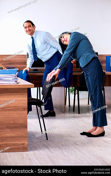 The two employees doing sport exercises in the office