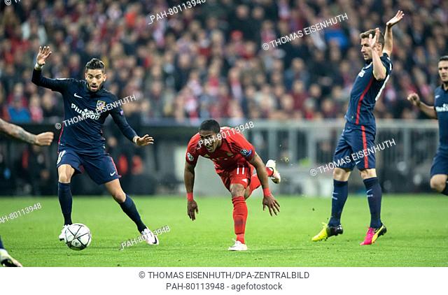 Bayern Munich's  Douglas Costa de Souza (c) and Madrid's Gabi (r) and Saul in action during the UEFA Champions League semi final soccer match FC Bayern Munich...