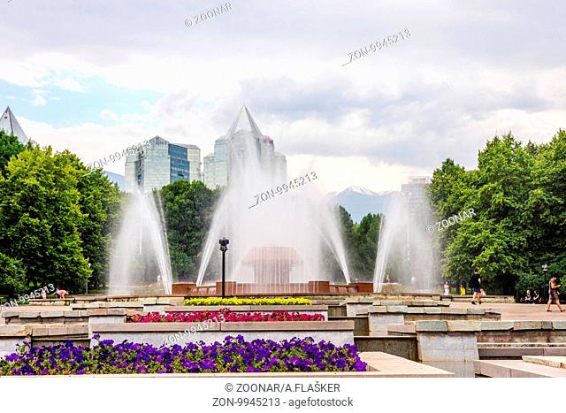 Water fountain with city skyline behind, Almaty, Kazakhstan