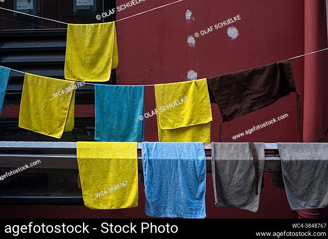 Singapore, Republic of Singapore, Asia - Damp towels hang for drying on a clothesline in the city district of Chinatown