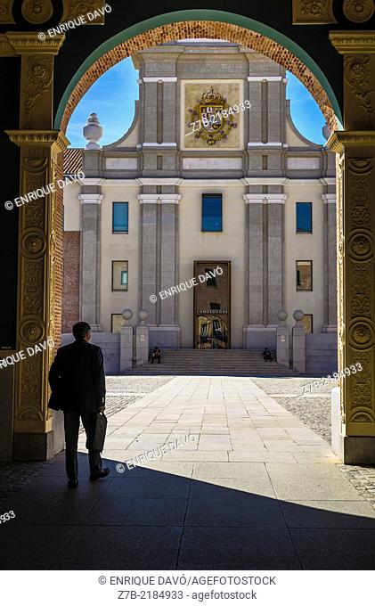 A man in a shadow in the entry of Conde Duque center, Madrid city, Spain