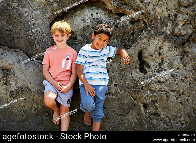 Children 5-10 years old, playing on the beach, Zumaia, Gipuzkoa, Basque Country, Spain