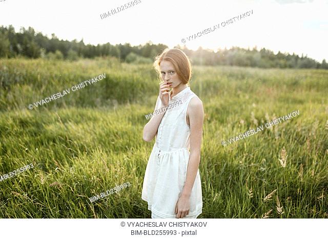 Portrait of pensive Caucasian girl standing in field