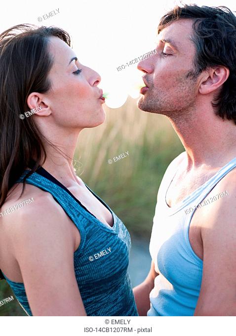 couple playing with bubble gum