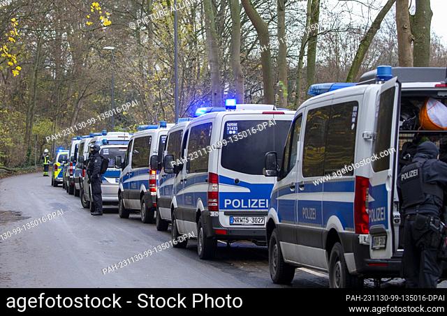 30 November 2023, North Rhine-Westphalia, Cologne: Police emergency vehicles are parked outside a school in Cologne Müngersdorf