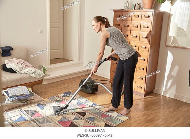 Woman vacuum cleaning at home