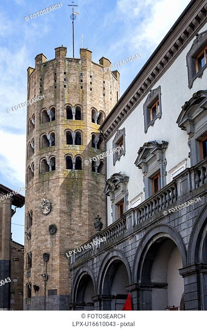 Close up view of twelve-sided Romanesque -Gothic tower of Sant'Andrea, beside the Renaissance Palazzo Comunale, with white stucco, ornate grey framed windows