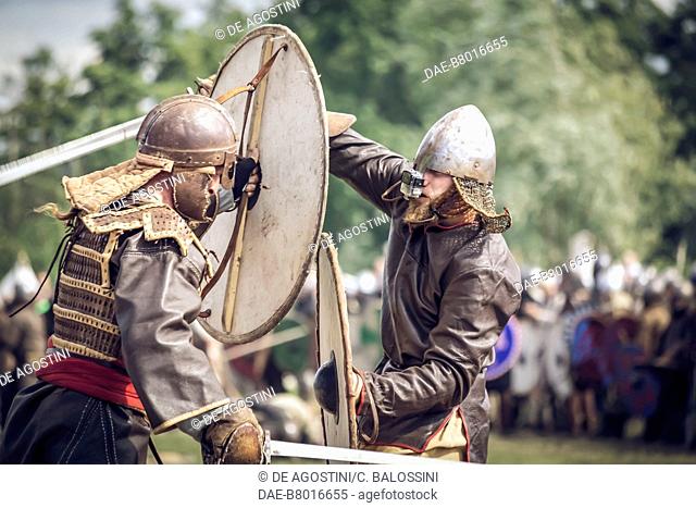 Warriors in battle with shields and swords, Festival of Slavs and Vikings, Centre of Slavs and Vikings, Jomsborg-Vineta, Wolin island, Poland