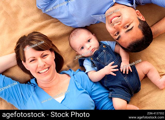 Mixed Race Family Playing Face Up on the Blanket