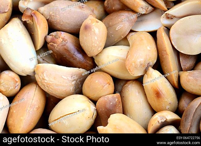 Peanut. A lot of small yellow nuts without peel. Background texture