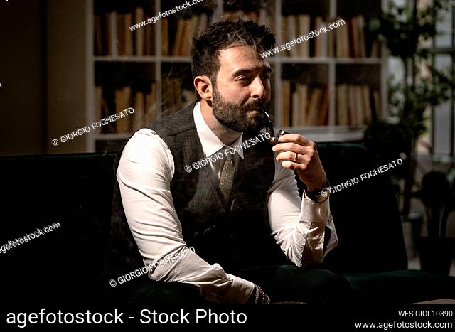 Portrait of bearded man smoking pipe